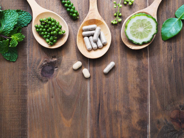 istock herbal pills in wooden spoon 941217790