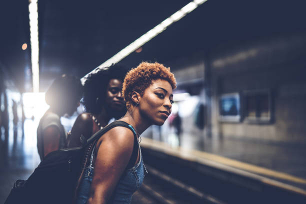 friends waiting the train at station - look for trains” imagens e fotografias de stock