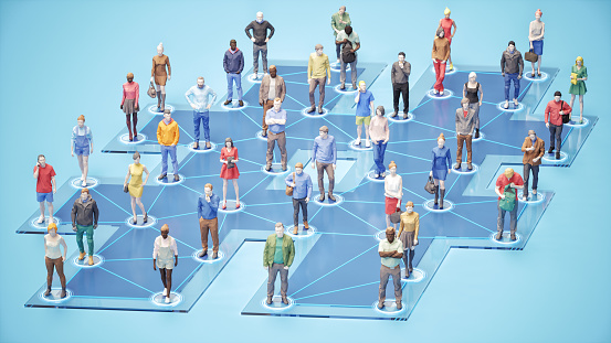 A group of miniature people connected together with social media on a hashtag symbol.