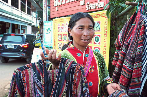 CHIANG MAI THAILAND - 30 January 2018: local woman from Mhong mountain tribe that locate close to Thailand and Myanmar border sell the hand made t-shirt at Doi Ang Khang, Chiang Mai, Thailand