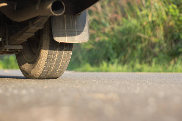 istock wheel car on paved road 941228924