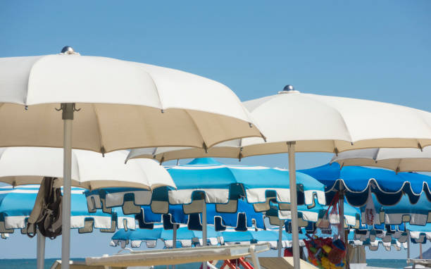 istock Beach umbrellas, gazebos and sun beds at Italian sandy beaches. Adriatic coast. Emilia Romagna region 941229242