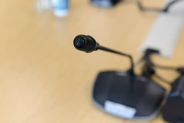 istock Selective focus conference microphones on the table in empty meeting room 941229770