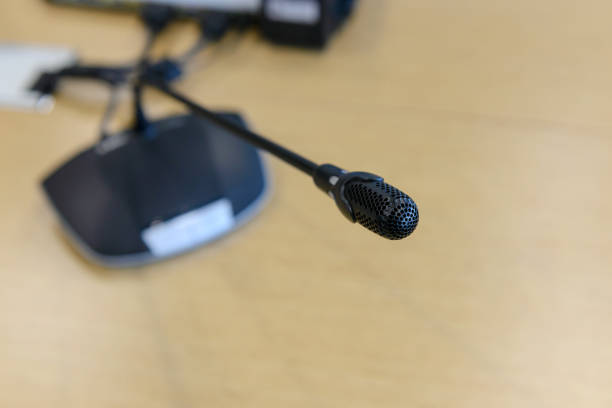 istock Selective focus conference microphones on the table in empty meeting room 941229806