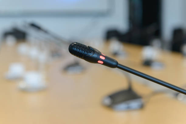 istock Selective focus conference microphones on the table in empty meeting room 941229836