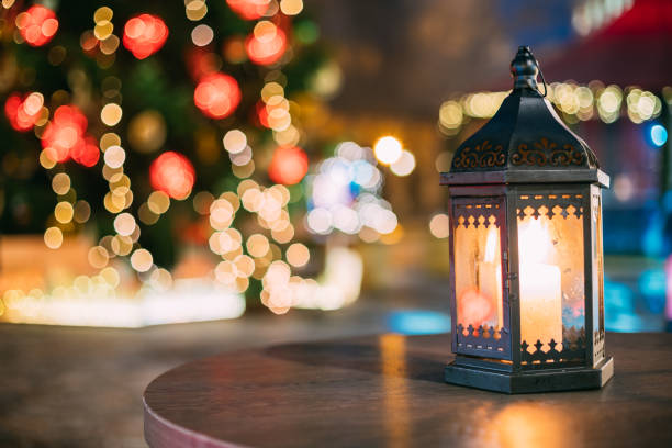 istock Christmas Lantern With Burning Candle On Bright Blurred Christmas Xmas Lights Background 941230064