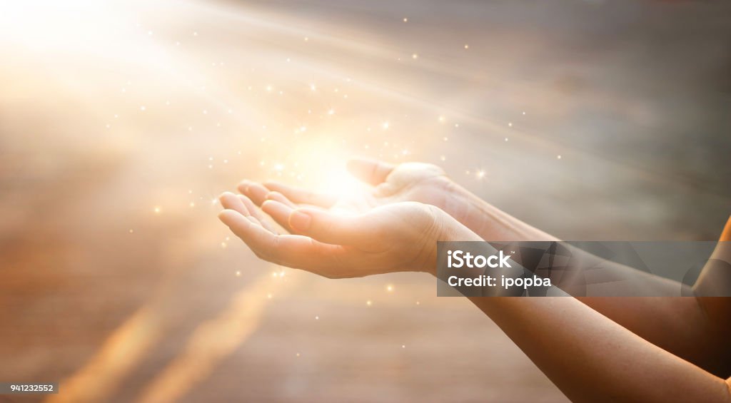 Woman hands praying for blessing from god on sunset background Hand Stock Photo