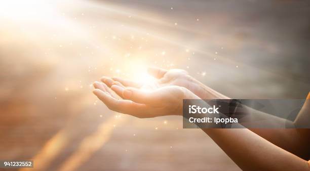 Woman Hands Praying For Blessing From God On Sunset Background Stock Photo - Download Image Now
