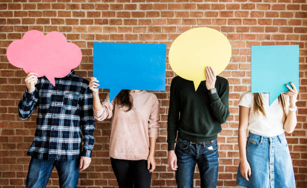 istock Friends holding up copyspace placard thought bubbles 941236790
