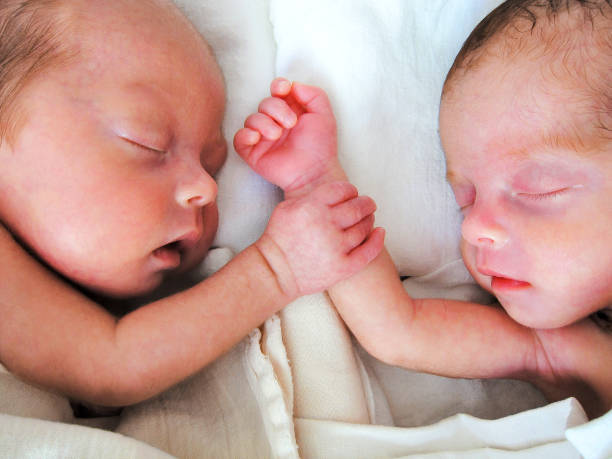 istock Newborn Premature Twins holding hands 941238320