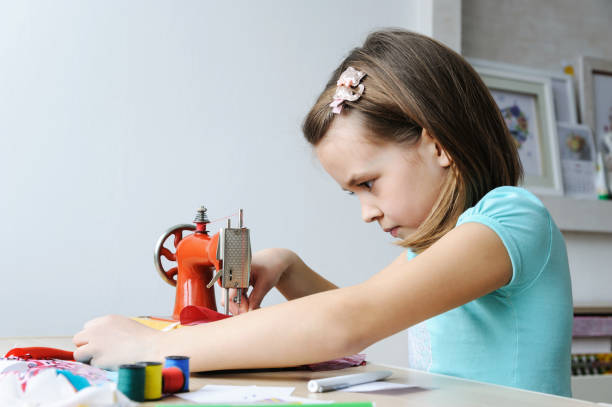 istock The girl is sewing on a sewing machine. 941242240