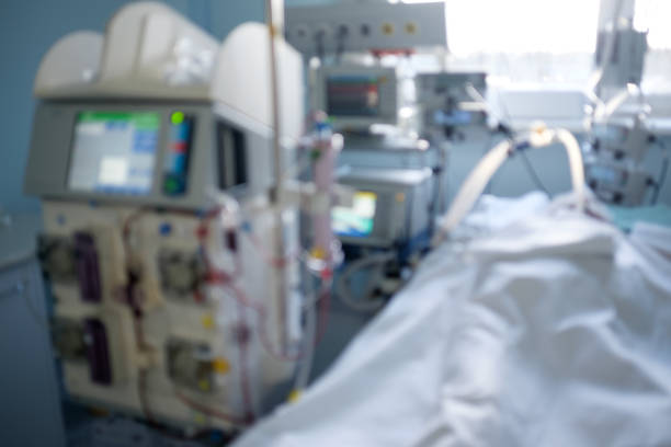 istock Blurred image of intensive care emergency room with hemodialysis machine, ventilator and patient in critical stance 941245566