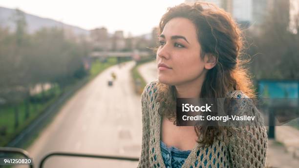 Attractive Young Woman Standing Outdoors Contemplating Stock Photo - Download Image Now