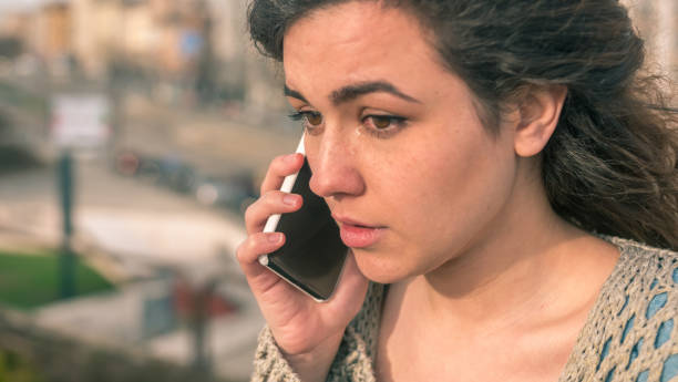 istock Sad girl talking on the phone crying 941250832