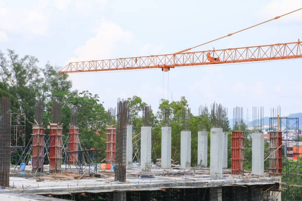 istock crane in construction building site on sky background 941254028