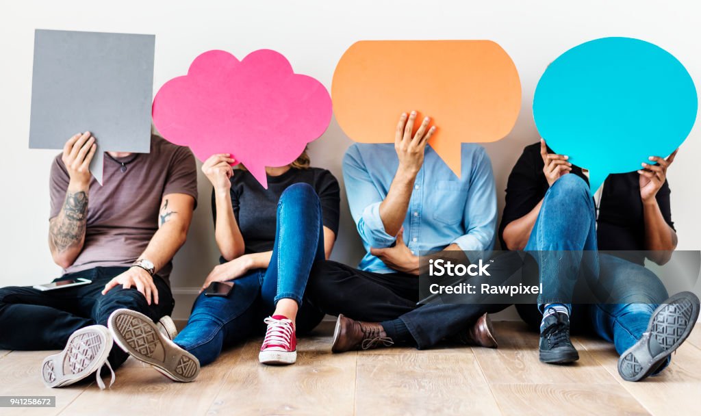 Group of diverse people with speech bubbles icons Speech Bubble Stock Photo