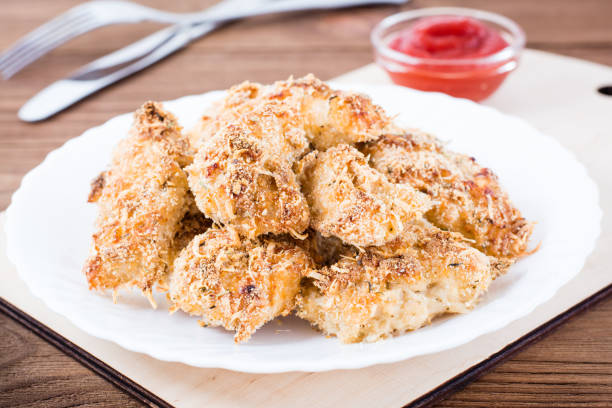 istock Homemade nuggets from chicken  on a plate 941260420