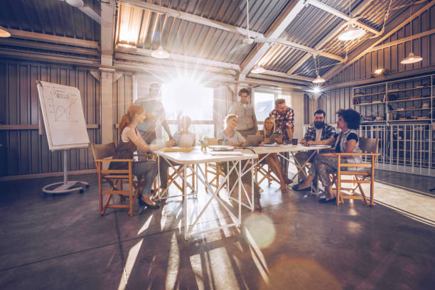 istock Large group of multi-tasking entrepreneurs working in a modern office. 941268162