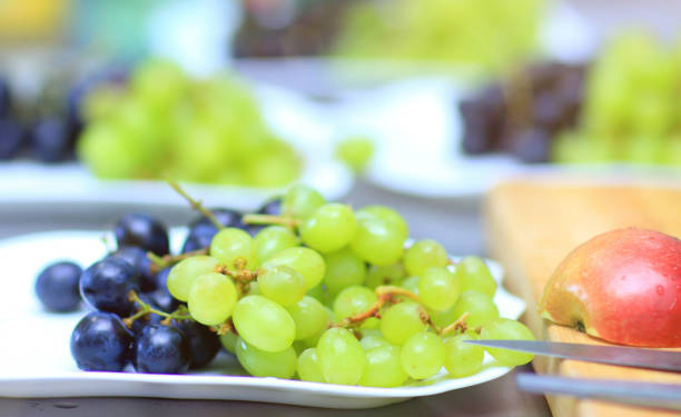 istock close up.grapes on plate on blurred background 941268432