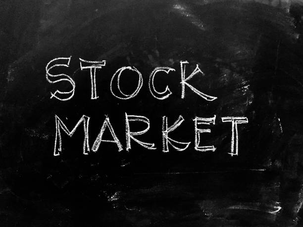 istock Stock Market handwritten on Blackboard - Stock Image 941268984