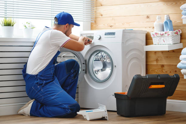 istock working man   plumber repairs  washing machine in   laundry 941268988