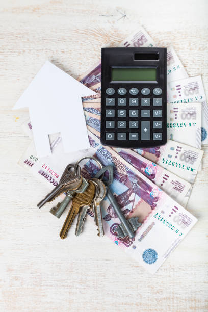 istock Cardboard house, keys,calculator and money 941272852