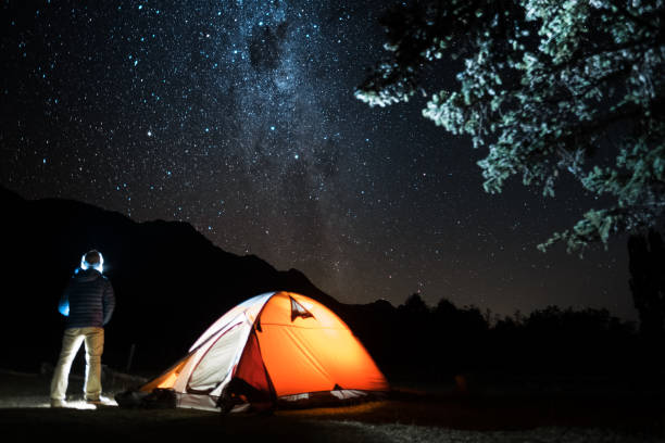 istock Hiker stands by the tent 941273248