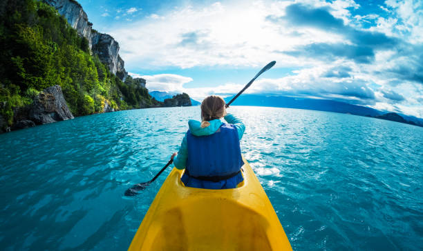 Woman paddles kayak in the lake with turquoise water Woman paddles kayak in the lake with turquoise water. Patagonia, Chile patagonia chile photos stock pictures, royalty-free photos & images