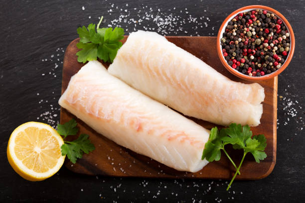 fresh fish fillet with ingredients for cooking - bacalhau imagens e fotografias de stock