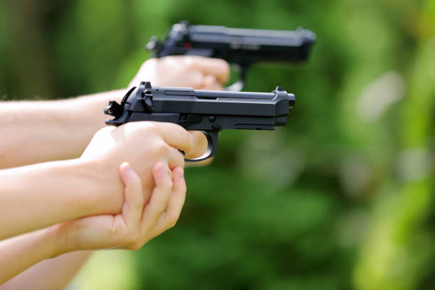 istock Young boys practice shooting guns on outdoor 941277714