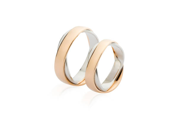 istock Two white and rose gold wedding rings isolated on white background 941278934