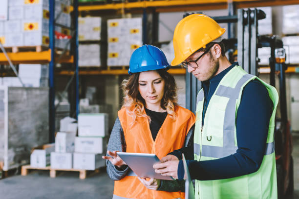 istock Industry manual workers using a digital pc tablet in the factory warehouse 941281712