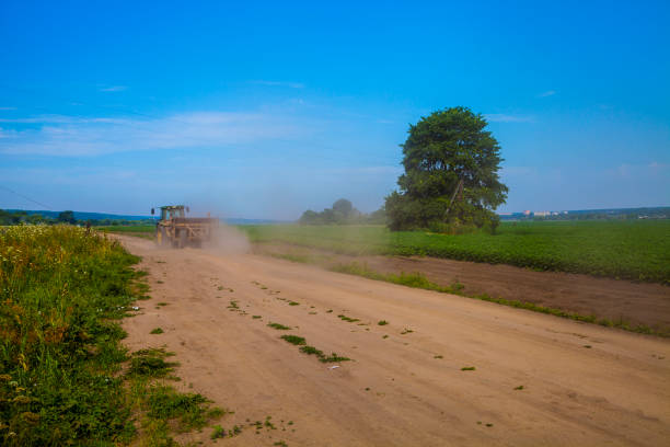 istock Road near the potato field 941282156