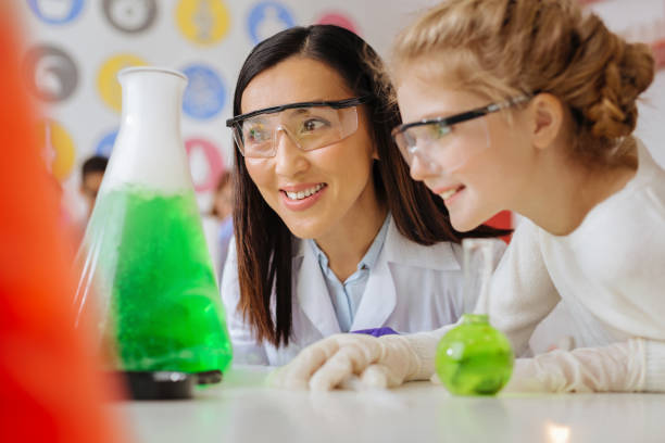 istock Upbeat teacher and student smiling while watching reaction 941282620