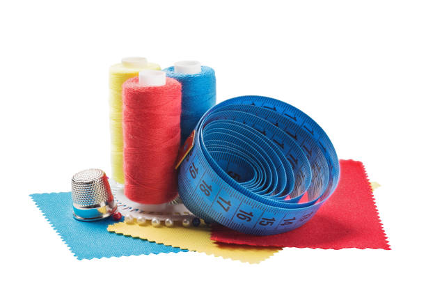 istock Sewing thread, fabric, needles for sewing on a white isolated background. Set for hobbies and handmade. 941285300