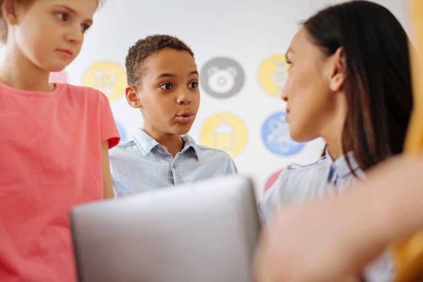 istock Cute boy communicating with his teacher after class 941285740