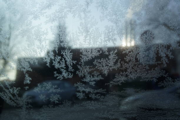 istock Ice frost on the car window during winter. 941289178