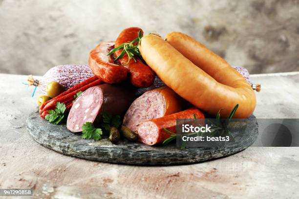 Food Tray With Delicious Salami Ham Fresh Sausages Cucumber And Herbs Meat Platter Stock Photo - Download Image Now