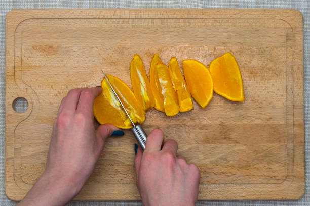 istock Cutted orange on a wooden board 941302696