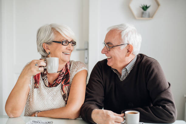 istock Mature couple having fun and drinking coffee 941306388