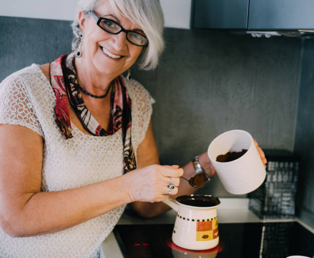 istock Senior woman making coffee 941306404