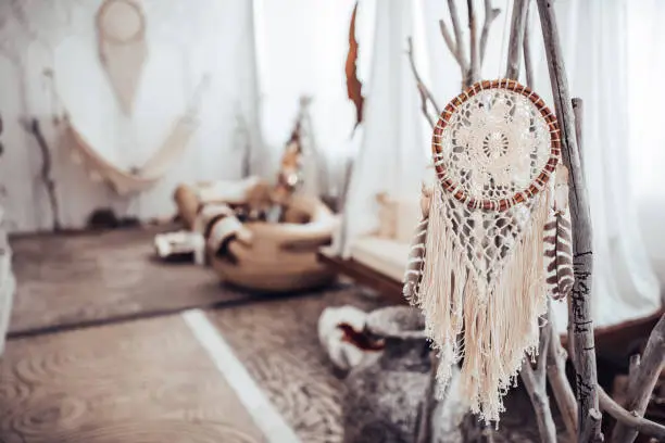 Modern light spa salon interior. Close-up of dreamcatcher.