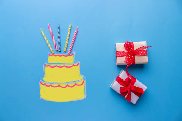 istock White birthday cake over blue background 941311604