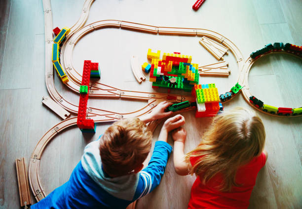 istock kids playing with toy railroad and trains 941312256