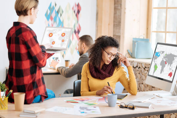 istock Determined woman working with her colleagues on a project 941312840