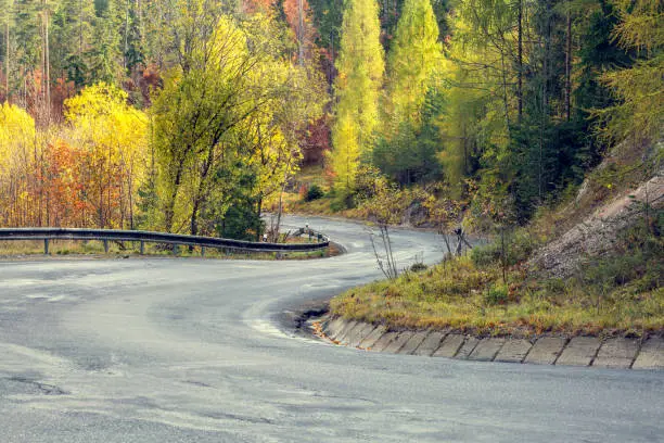Photo of Awesome view of the asphalt road in the autumn scenery.