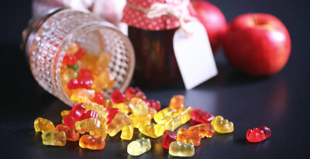 istock Marmalade in a vase on the table. Sweets in a bowl on a black ba 941313584