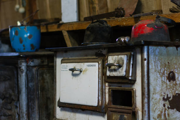 istock An old, white, worn cooking range with two old hot water pots on it 941317392