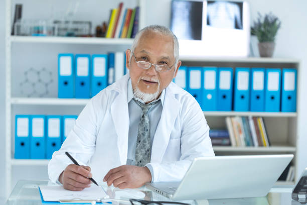 istock Medical specialist using laptop in cabinet 941317506