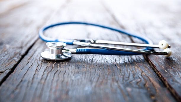 Stethoscope with blue tube on dark wood perspective view. Stethoscope with blue tube on dark wood perspective view with copy space. health and medical concept. pulse orlando night club & ultra lounge stock pictures, royalty-free photos & images